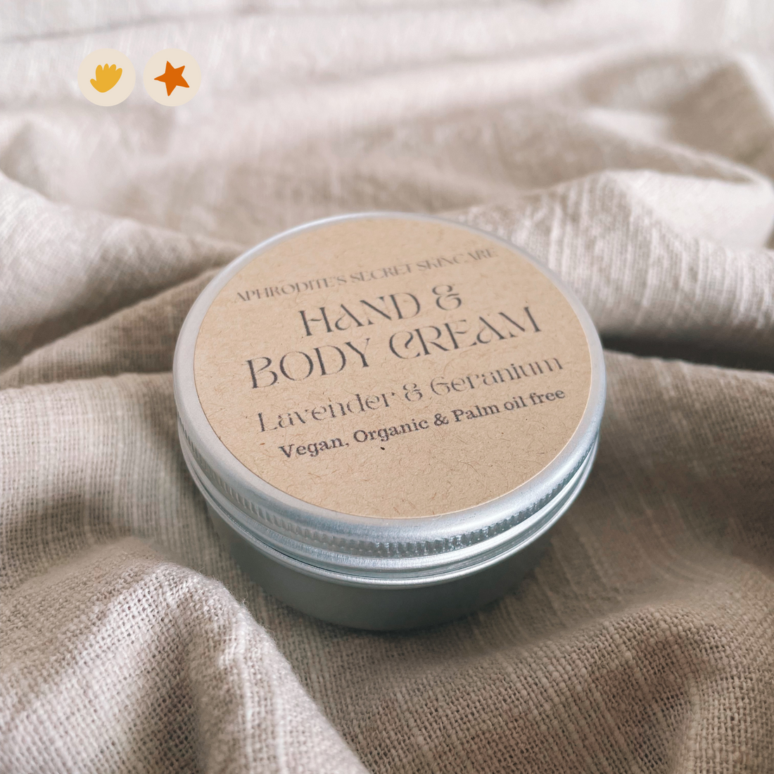 Metal jar of hand and body cream on a linen backdrop