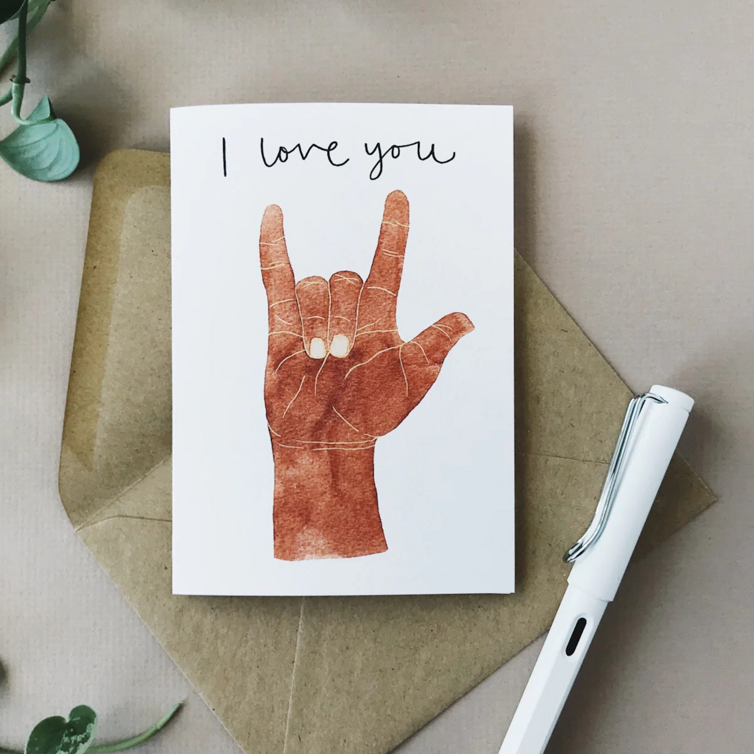 Card with a dark skinned hand doing the &quot;I Love You&quot; sign language sign with the words &quot;I love you&quot; in a script font.