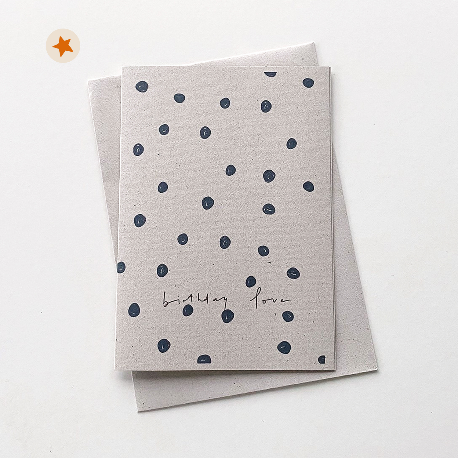 Card with navy doodled dots and the handwritten words &quot;Birthday Love&quot;
