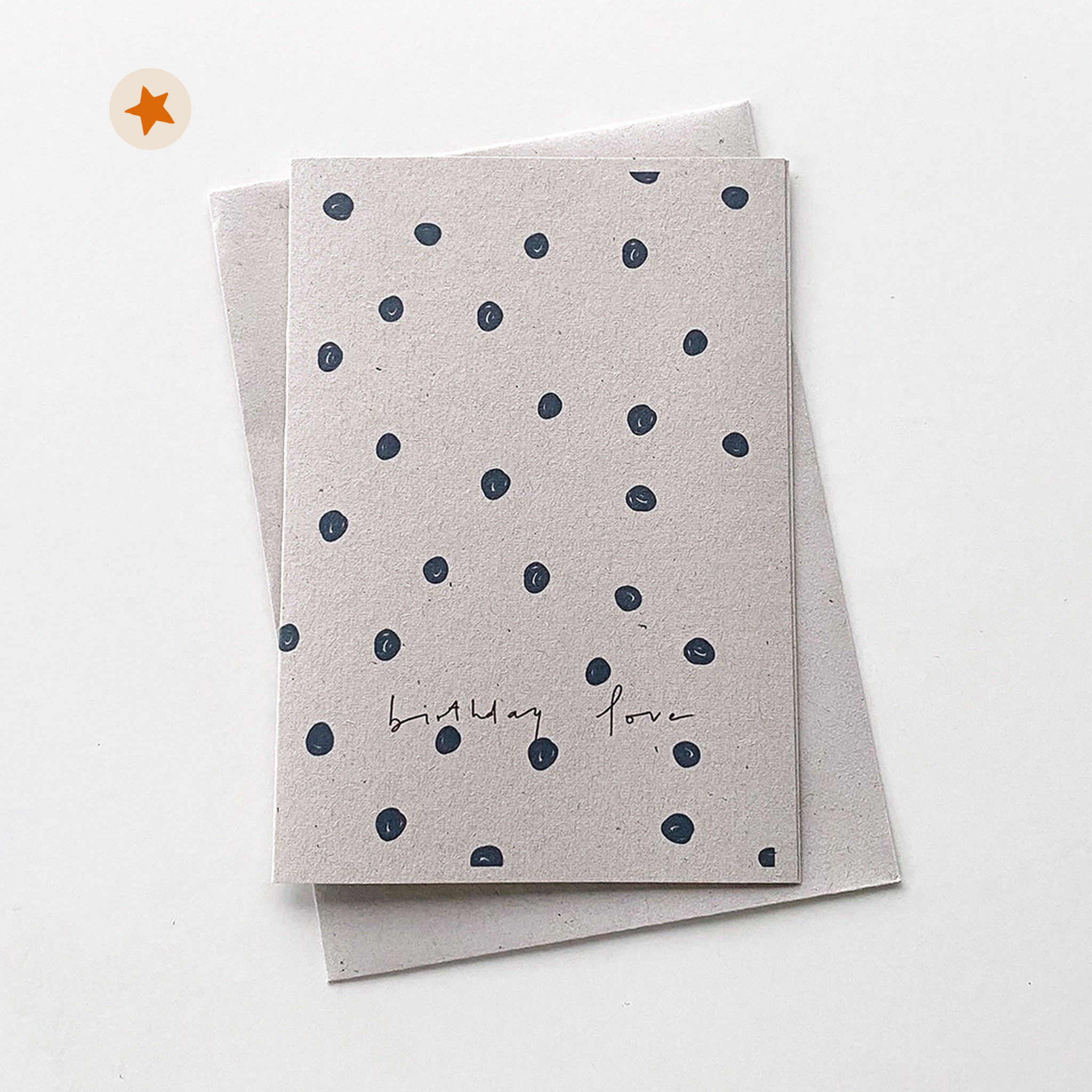Card with navy doodled dots and the handwritten words &quot;Birthday Love&quot;