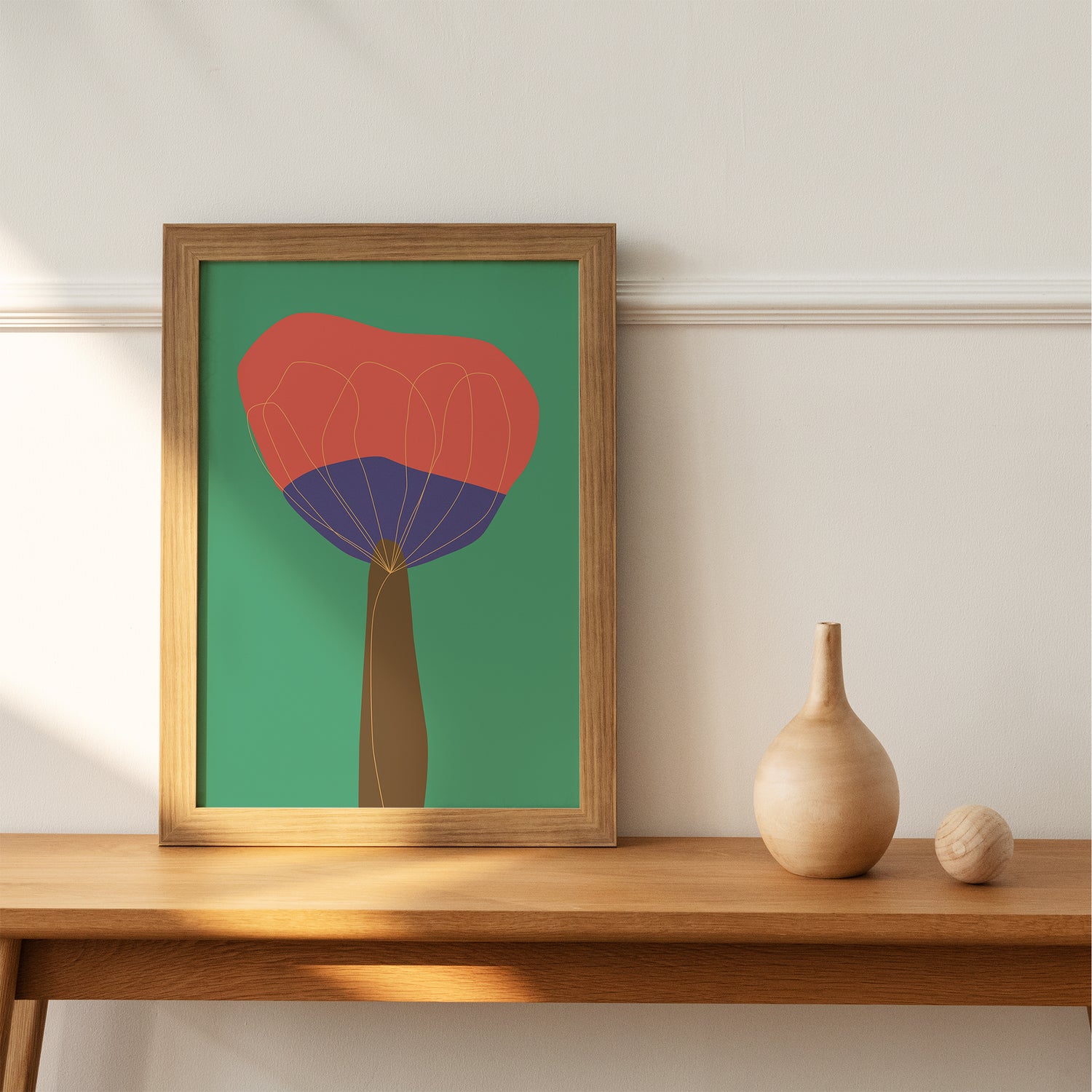 Frame on a shelf with an abstract illustration of a red and purple flower on a green background with a yellow outline
